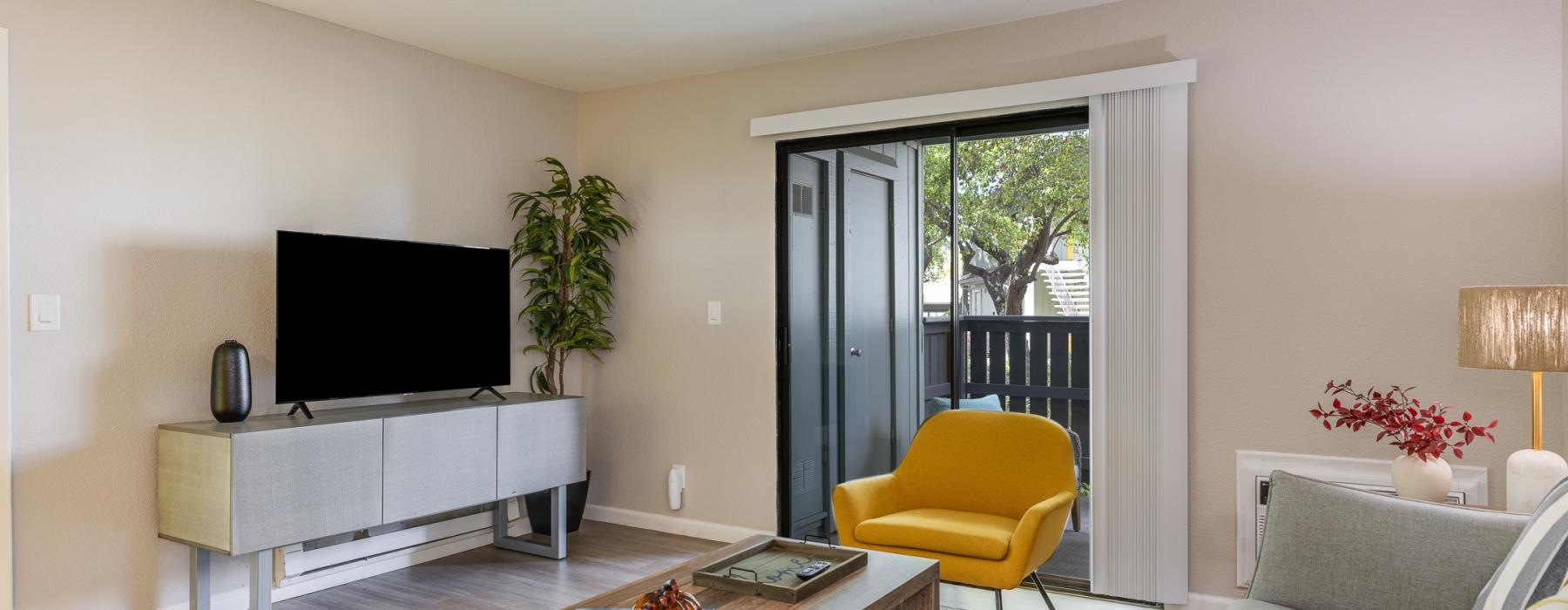 a living room with a tv and couches