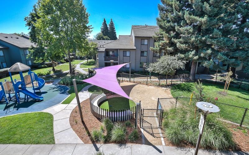 a backyard with a patio and umbrellas