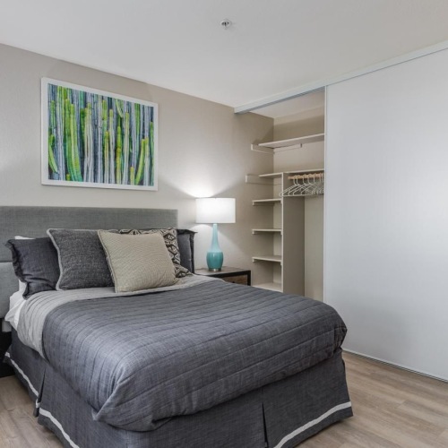 a bedroom with a bed and lamps